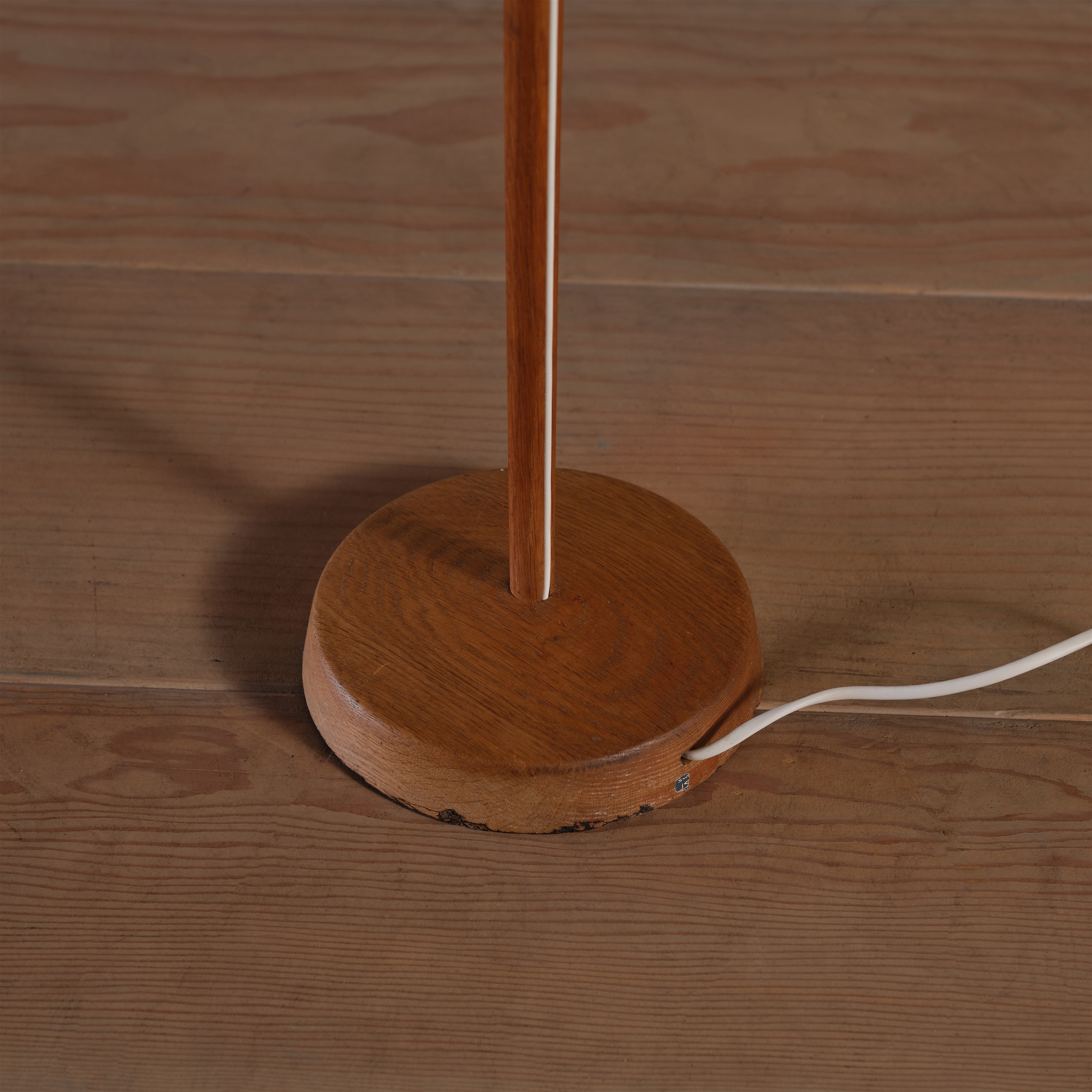 a wooden table lamp on a wooden floor
