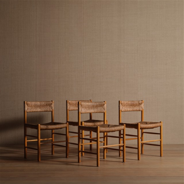 a group of four chairs sitting next to each other