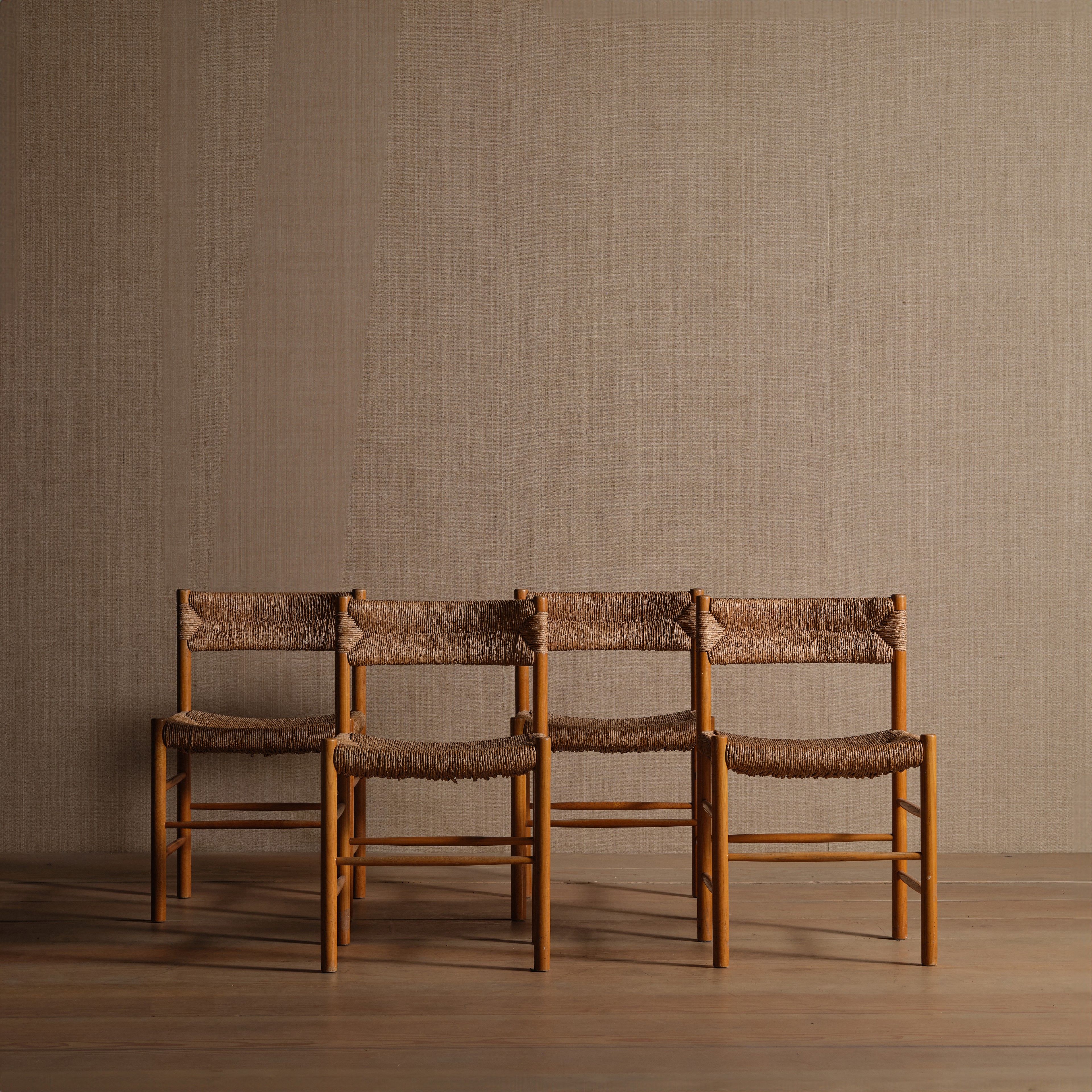 a group of three chairs sitting on top of a wooden floor