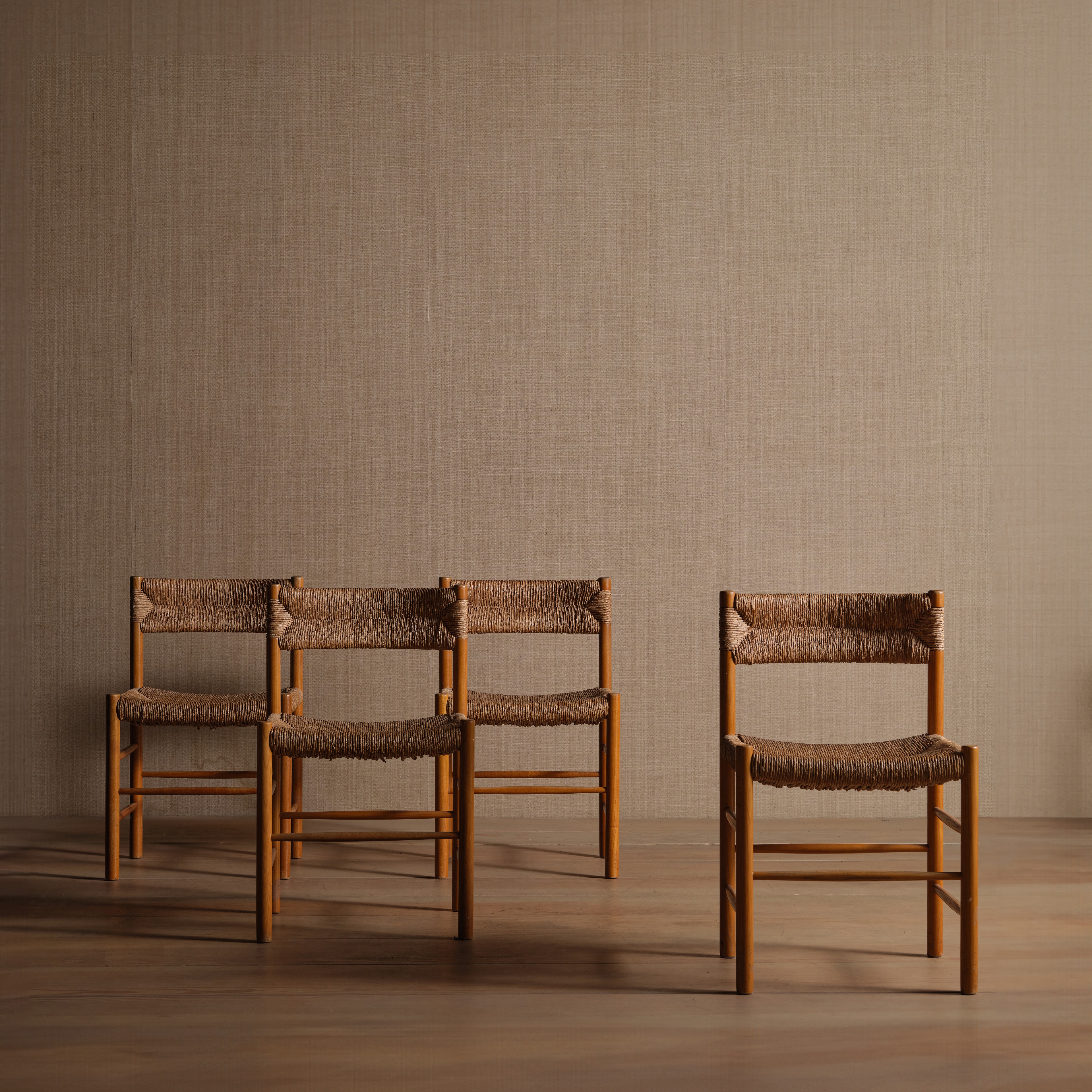a set of four chairs sitting on top of a hard wood floor