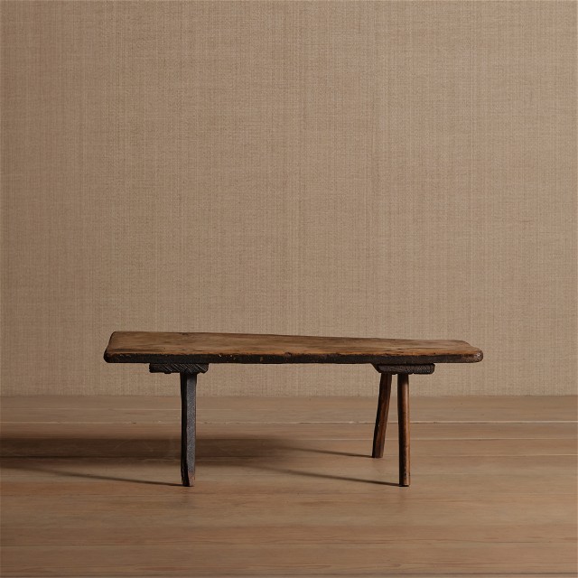 a wooden bench sitting on top of a wooden floor