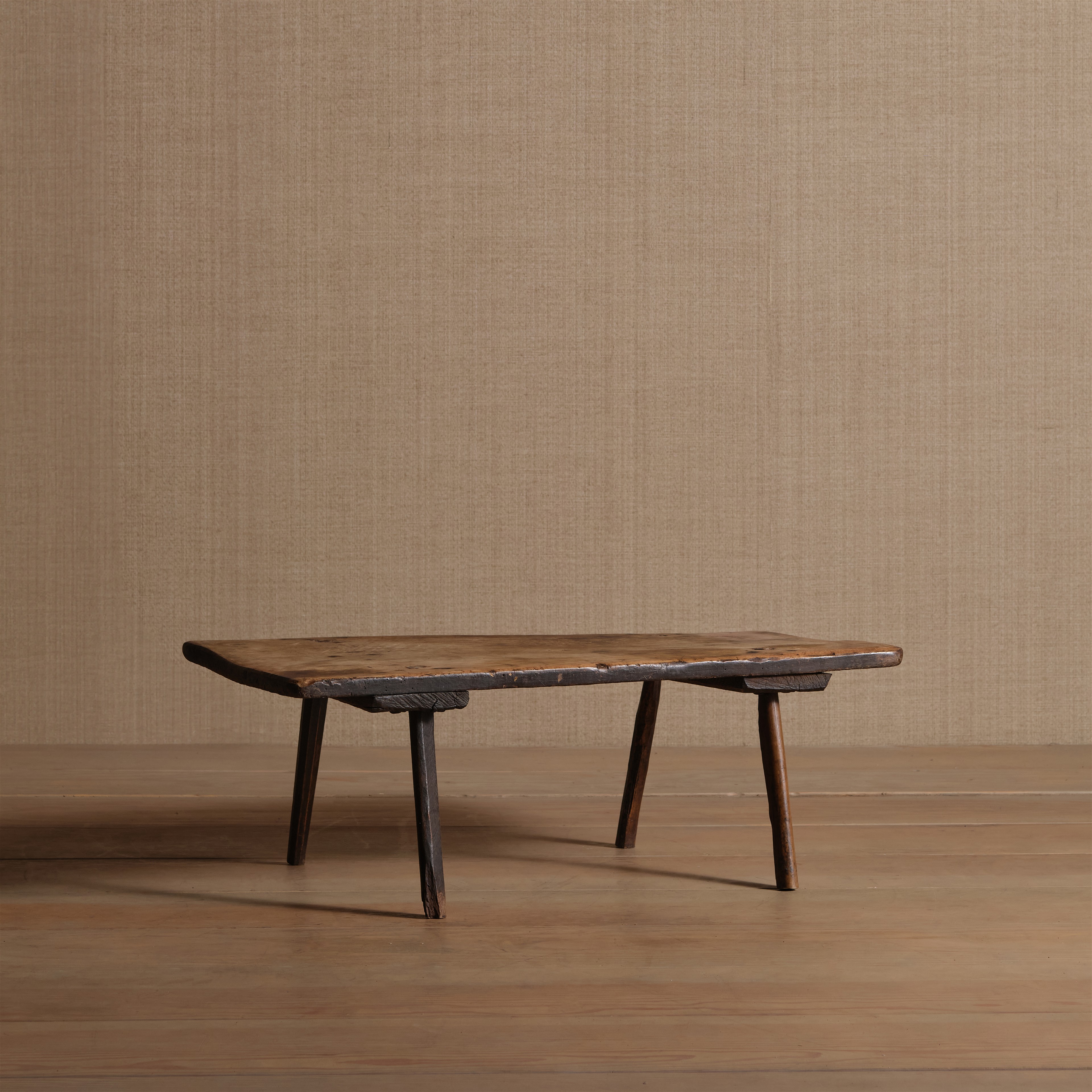 a wooden table sitting on top of a wooden floor
