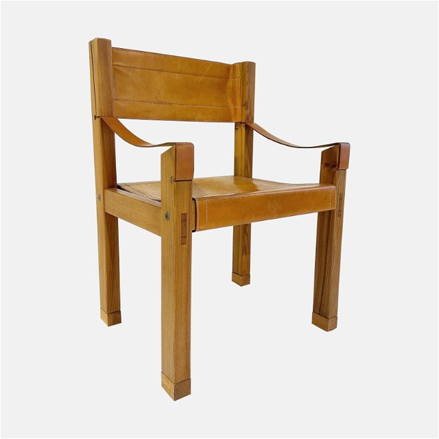 a wooden chair with a leather seat on a white background