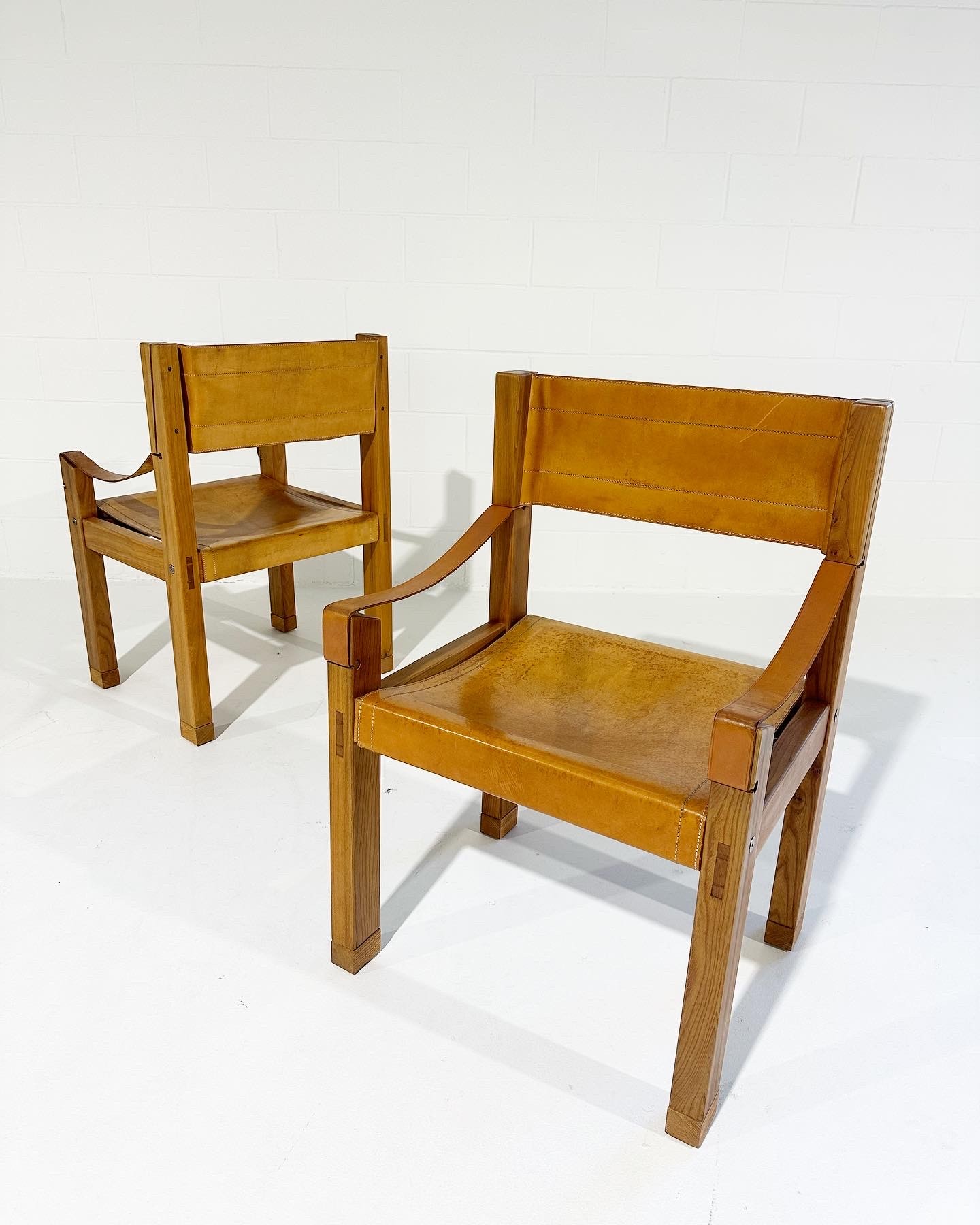 a couple of wooden chairs sitting next to each other