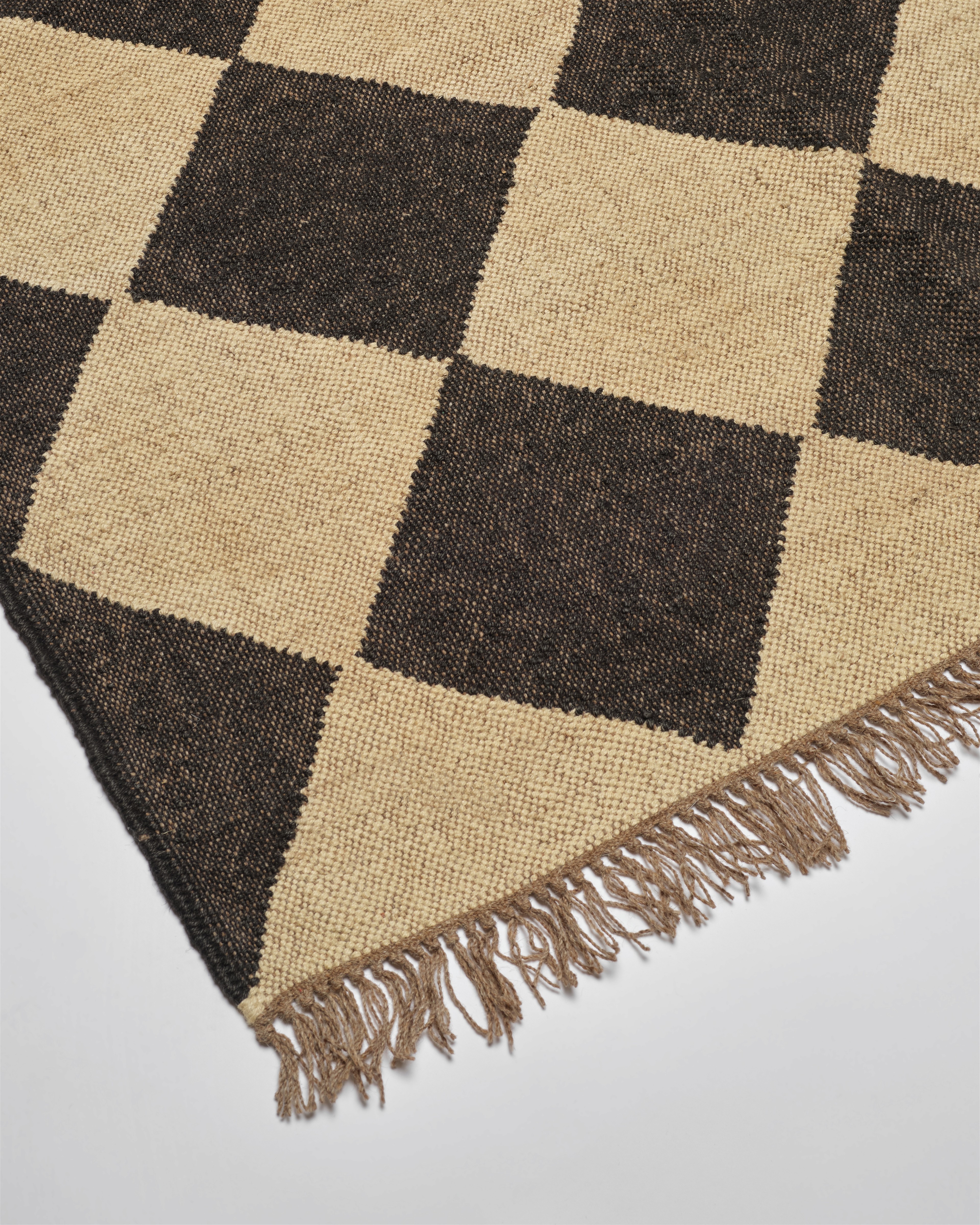 a brown and beige rug with a checkerboard pattern