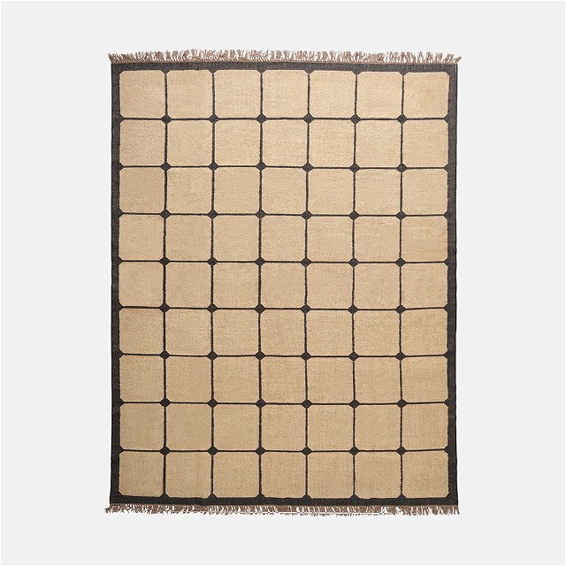 a beige rug with squares and fringes