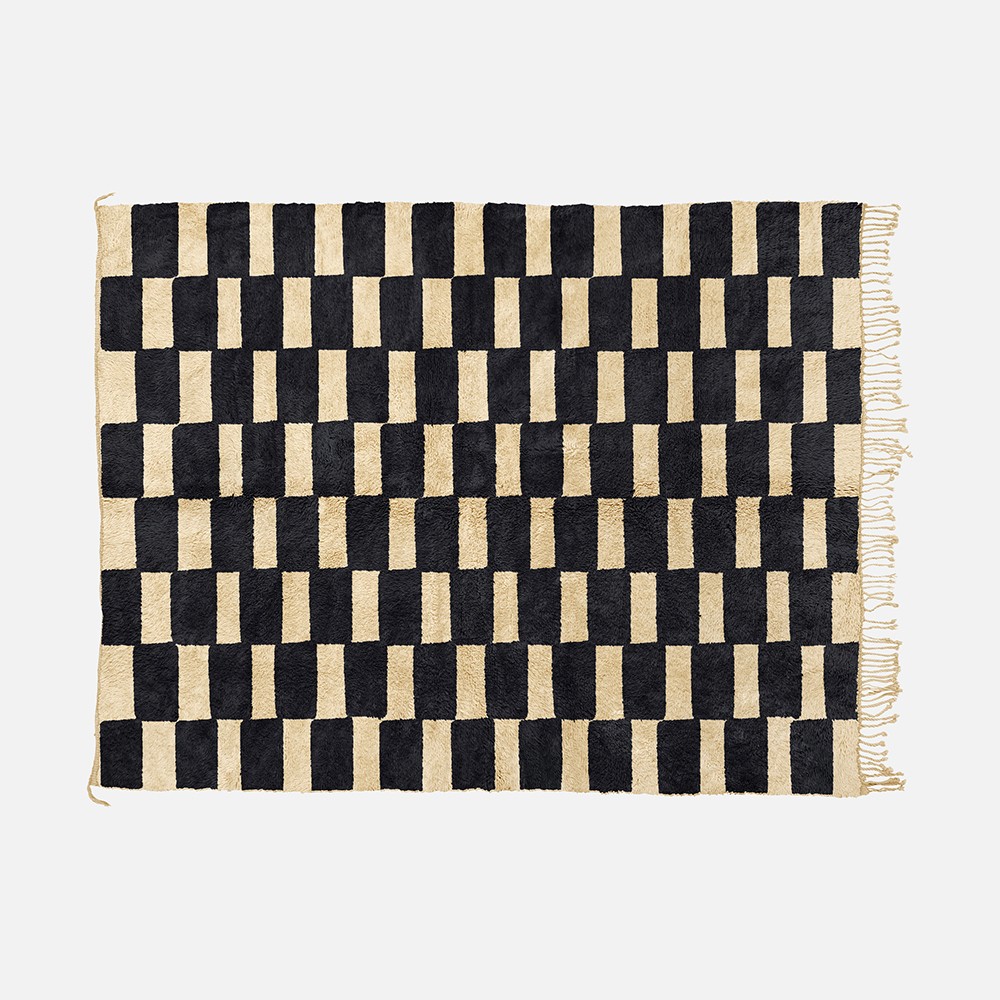 a black and white checkered rug with fringes
