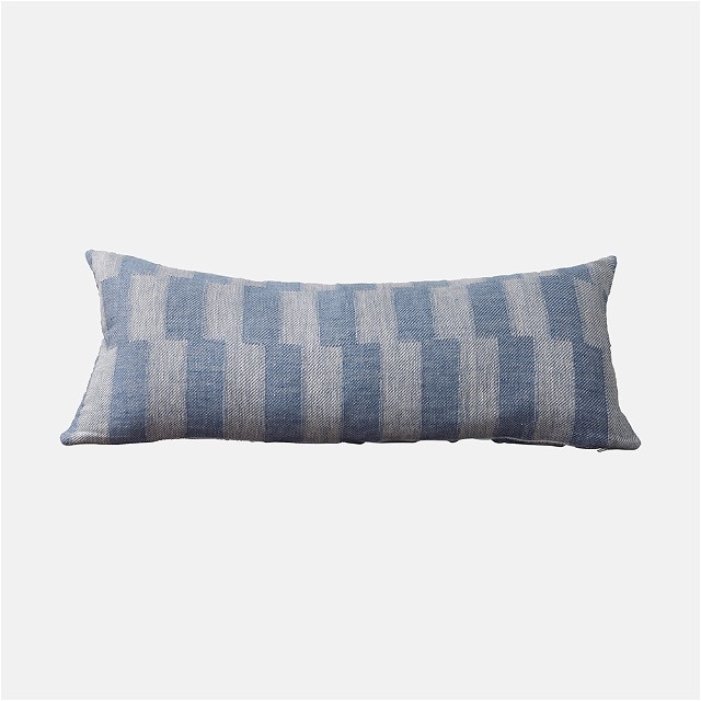 a blue and white pillow on a white background