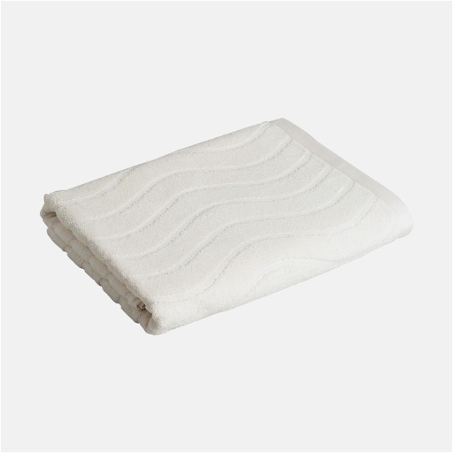 a white towel folded on top of a white surface