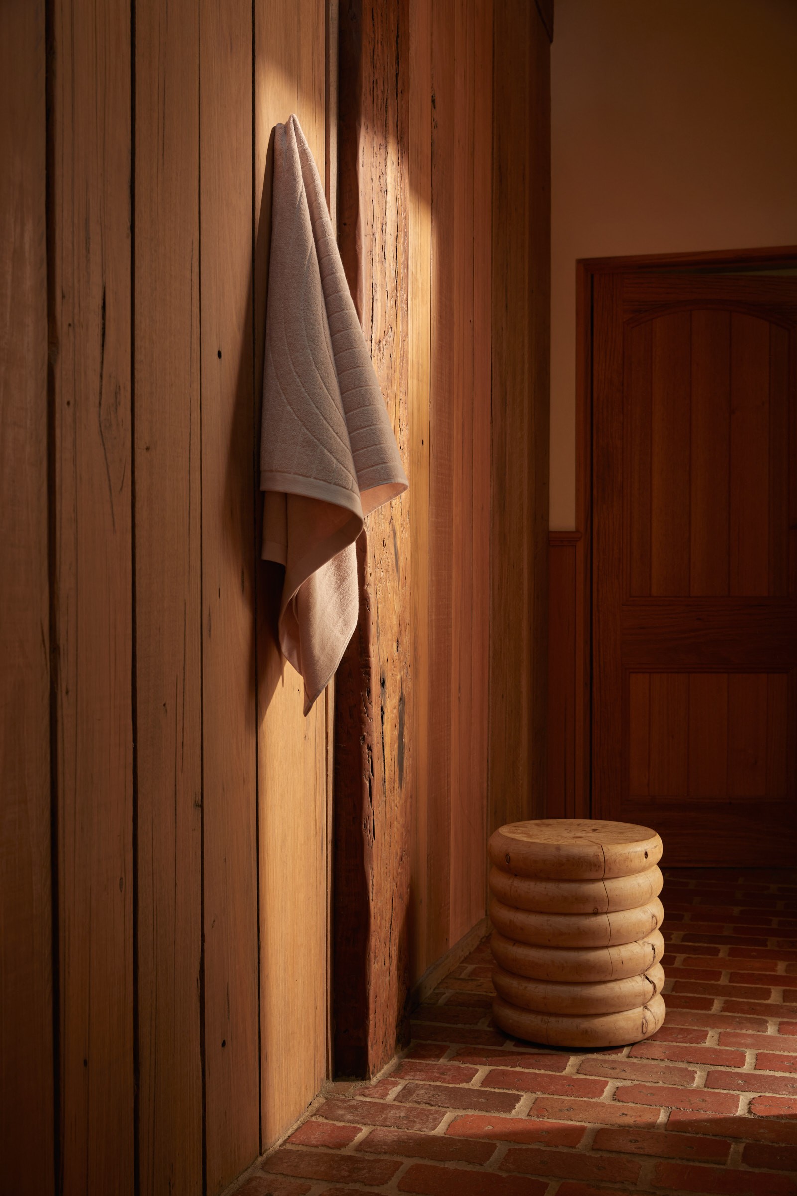a stack of towels hanging on a wooden wall