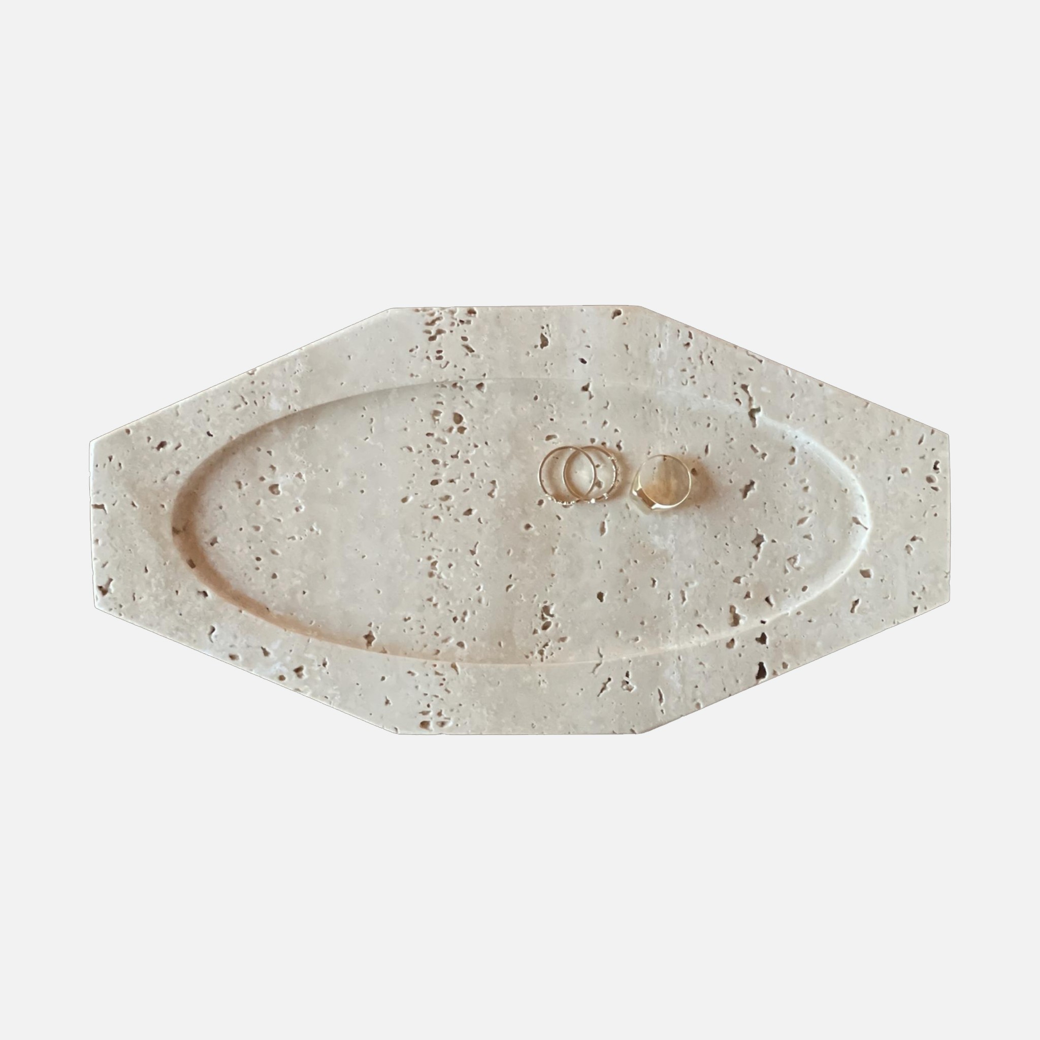 a white marble tray with two rings on it