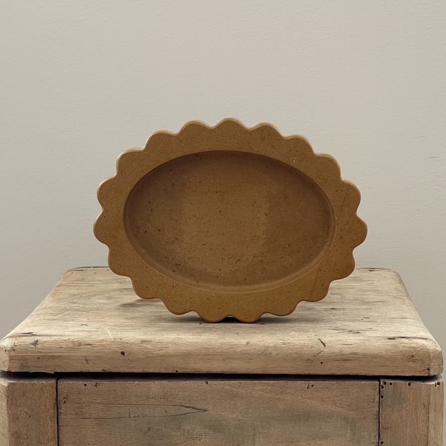 a brown bowl sitting on top of a wooden box