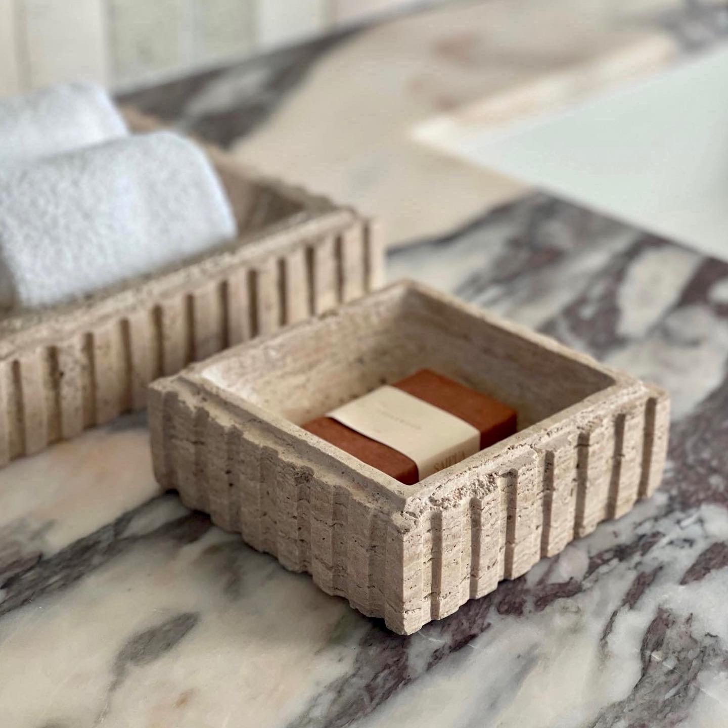 a couple of wooden containers sitting on top of a marble counter