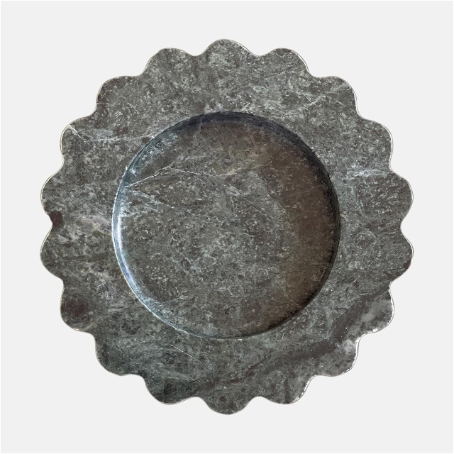 a metal plate with a circular design on it