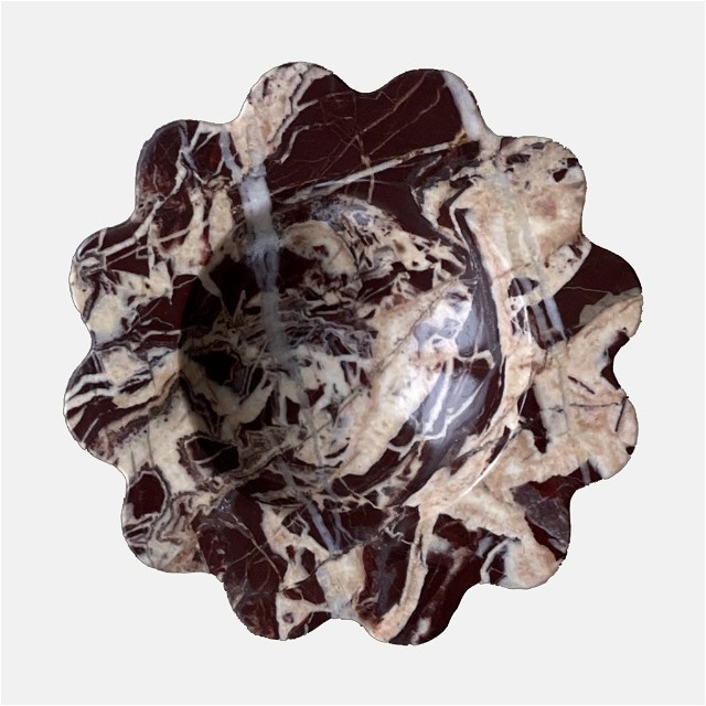 a brown and white flower shaped object on a white background