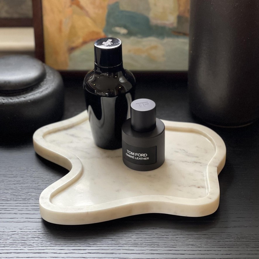 a bottle of cologne sitting on top of a tray