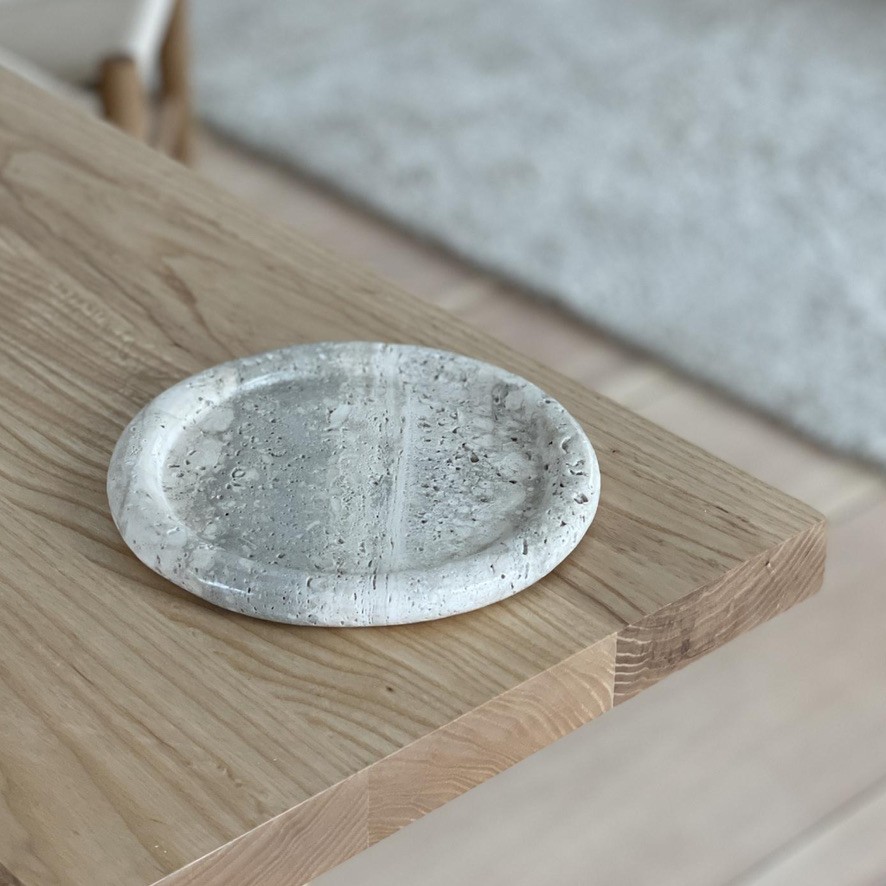a white plate sitting on top of a wooden table
