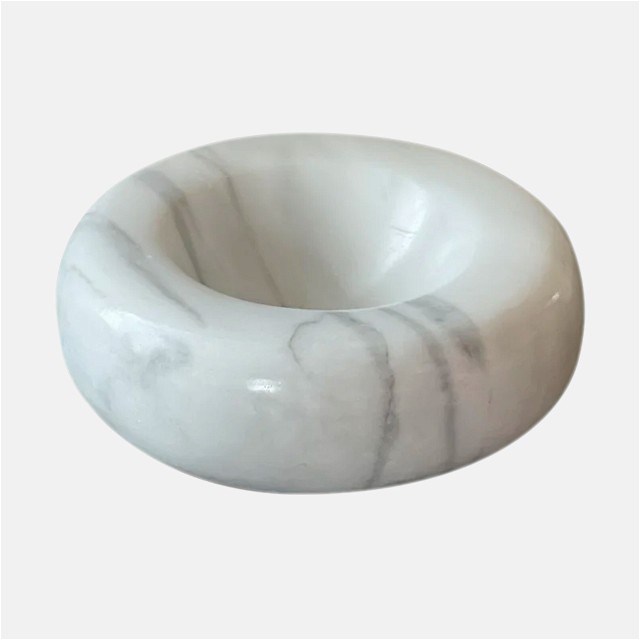 a white marble bowl sitting on top of a table