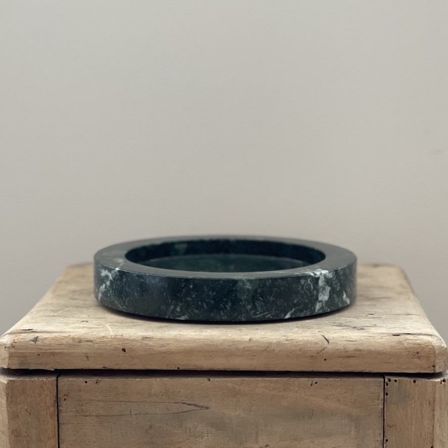 a wooden box with a black ring on top of it