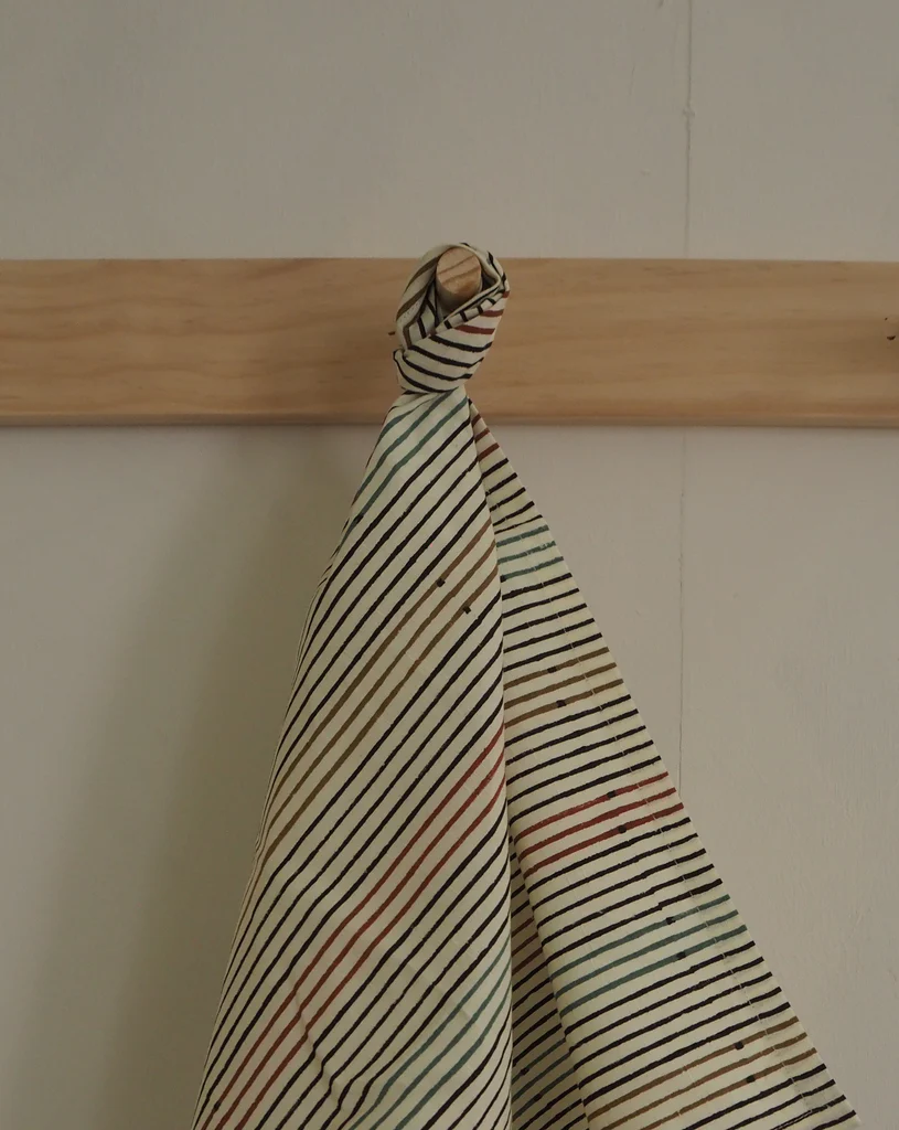 a folded piece of cloth hanging on a wall