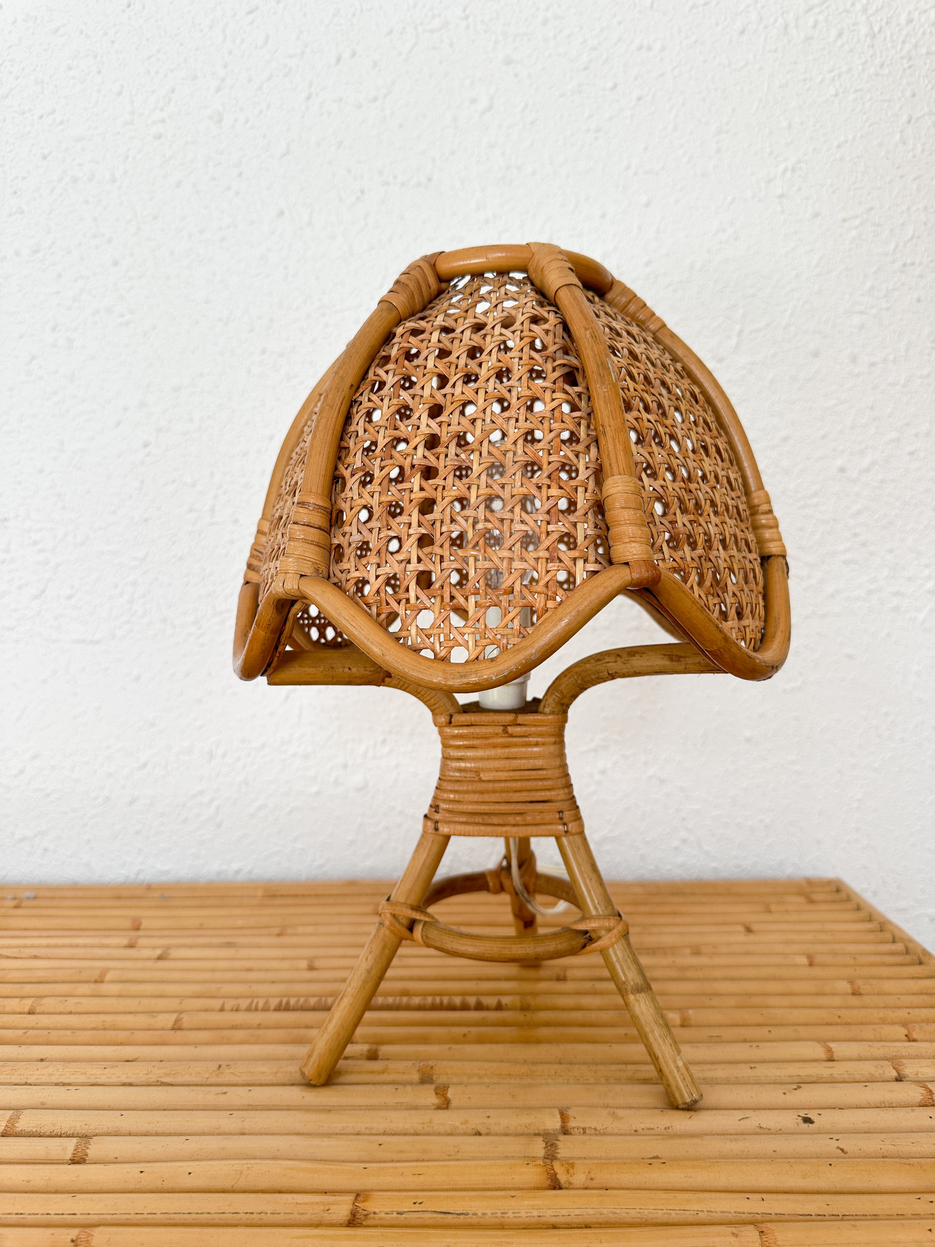 a wicker chair sitting on top of a wooden table