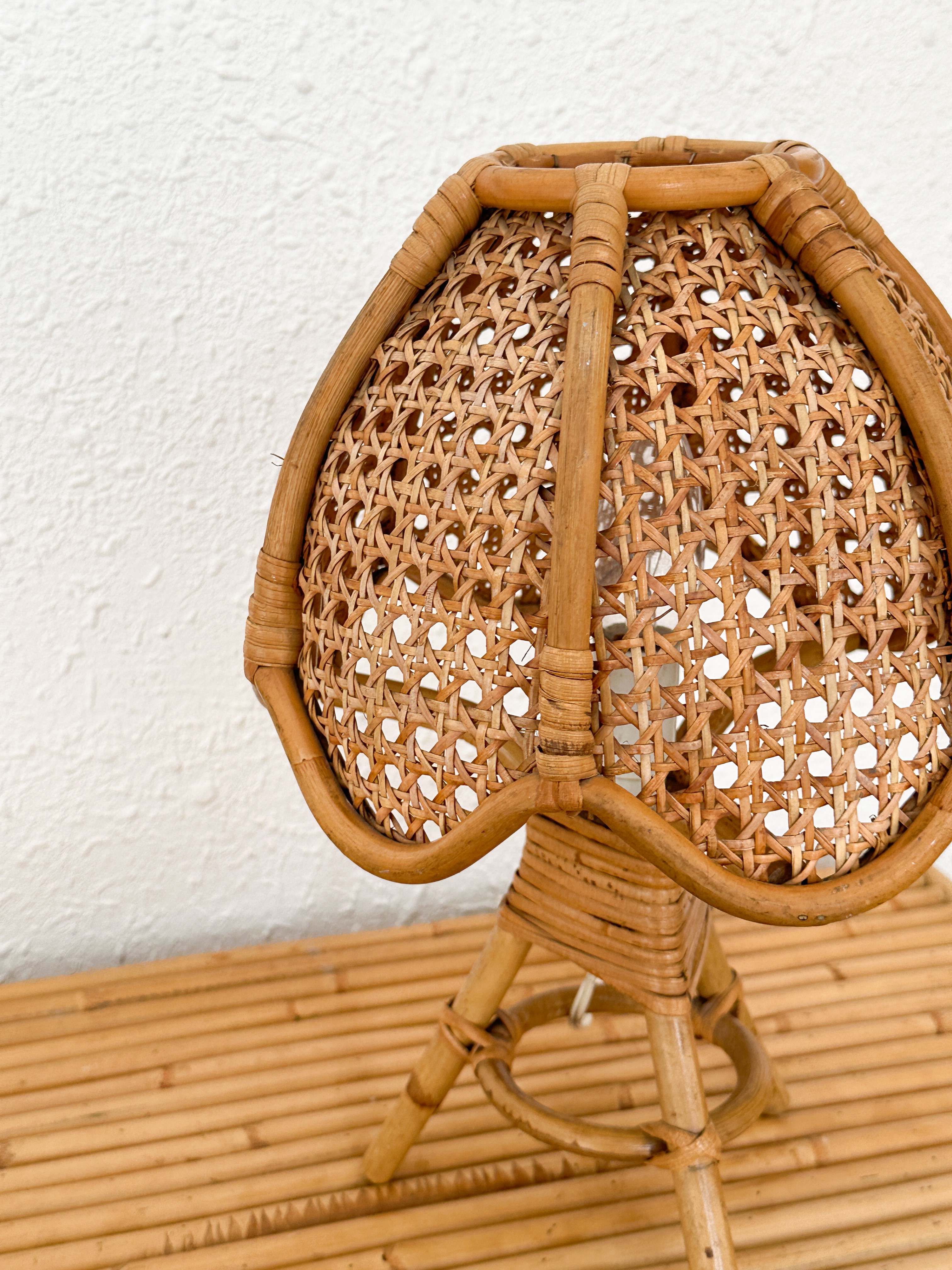 a wicker chair sitting on top of a wooden floor