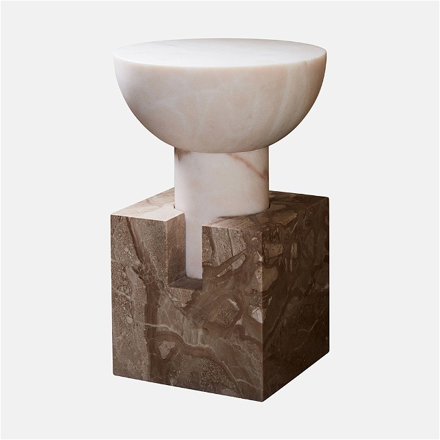 a white bowl sitting on top of a marble block