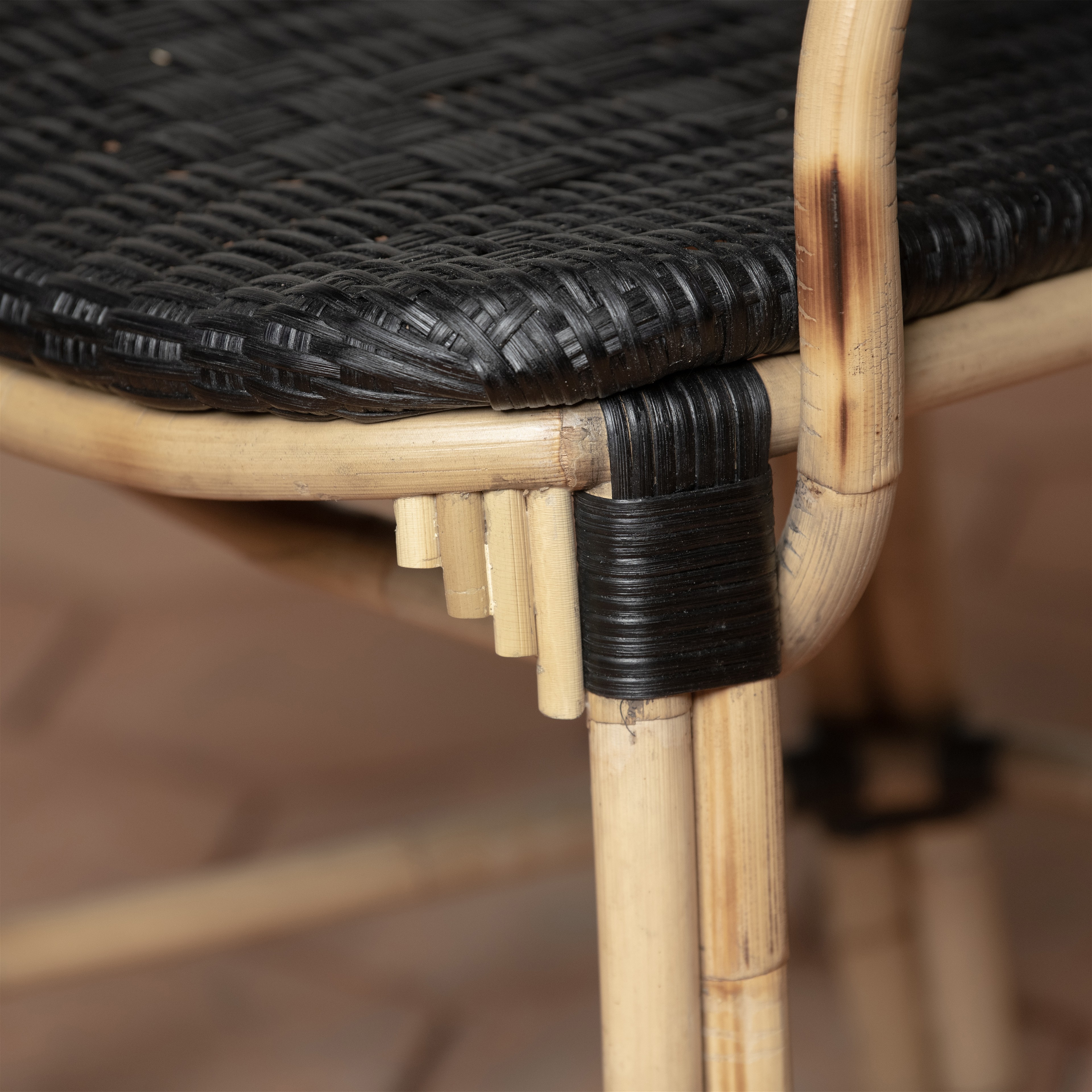 a close up of a black wicker chair