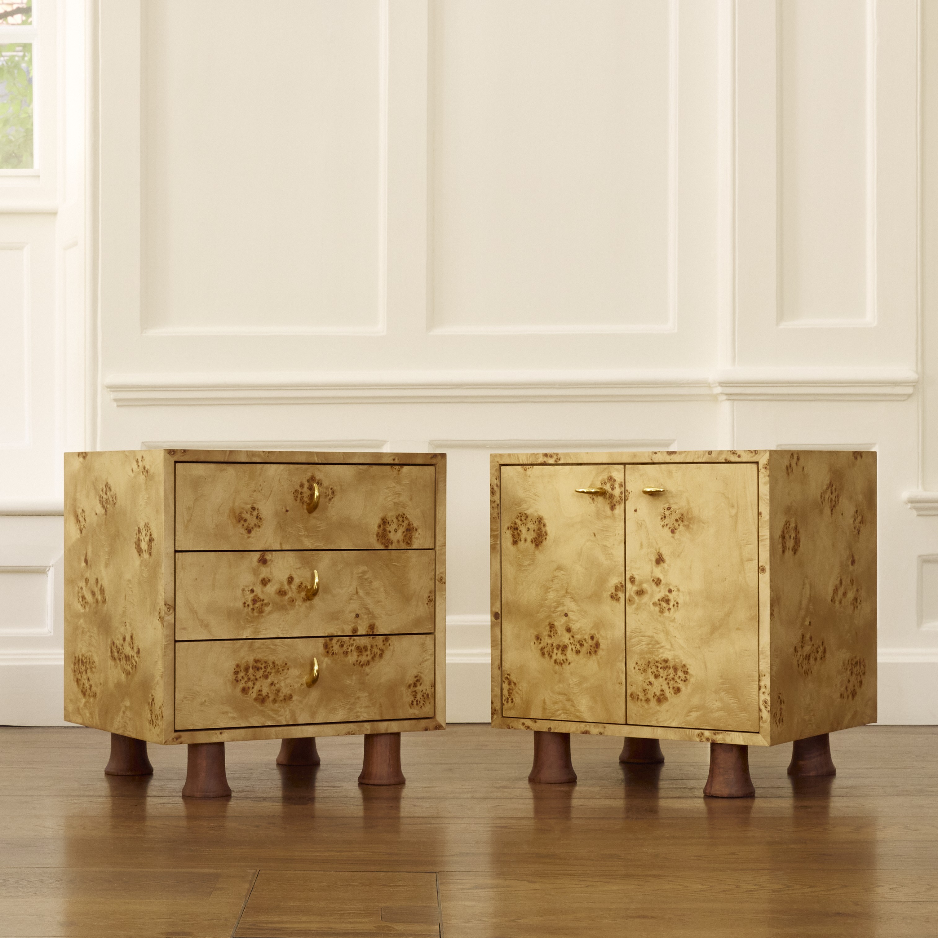a pair of golden chests sitting on top of a hard wood floor
