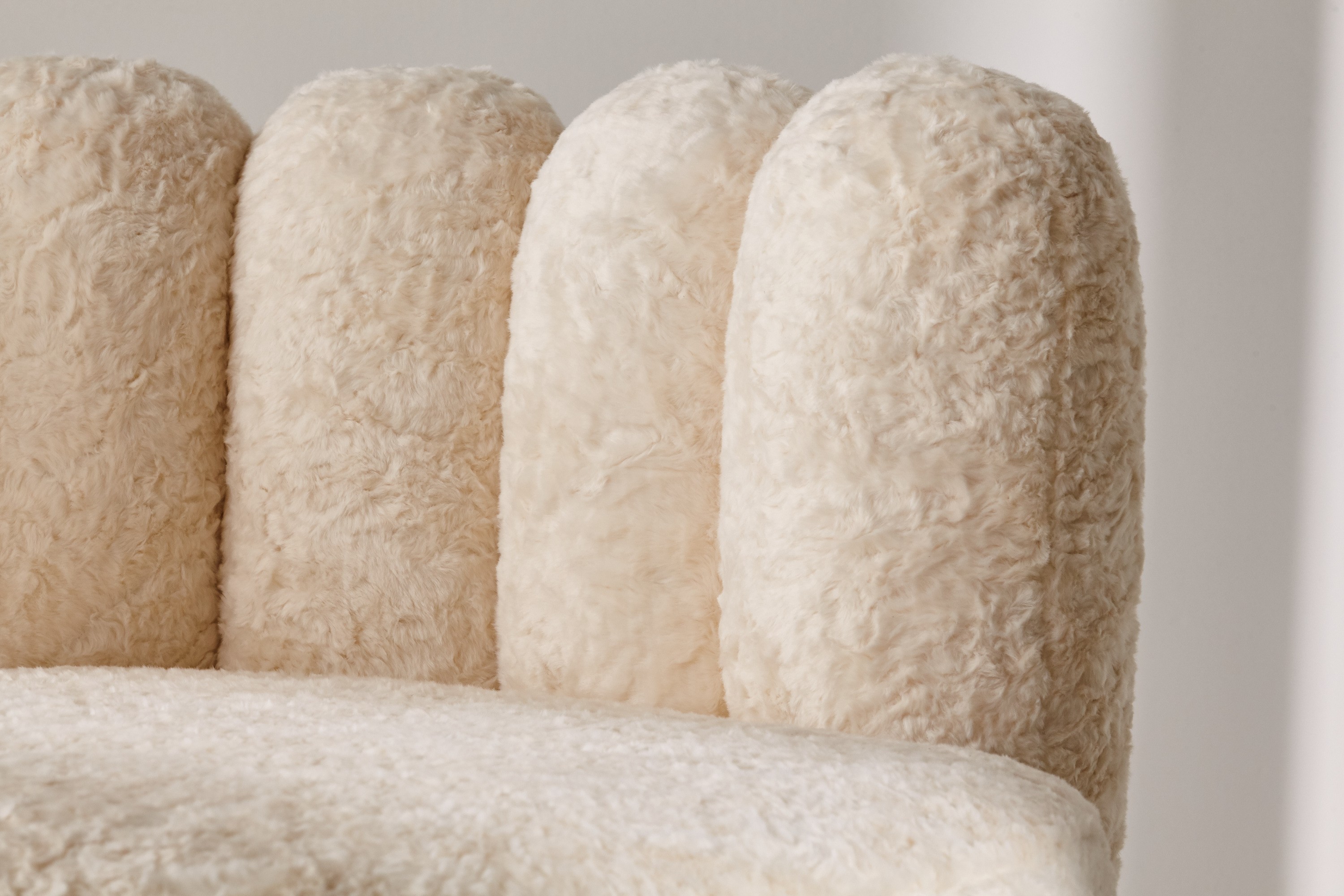 a close up of a chair made of sheepskin