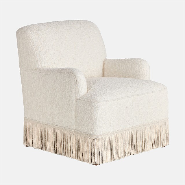a white chair with a fringe trim around it