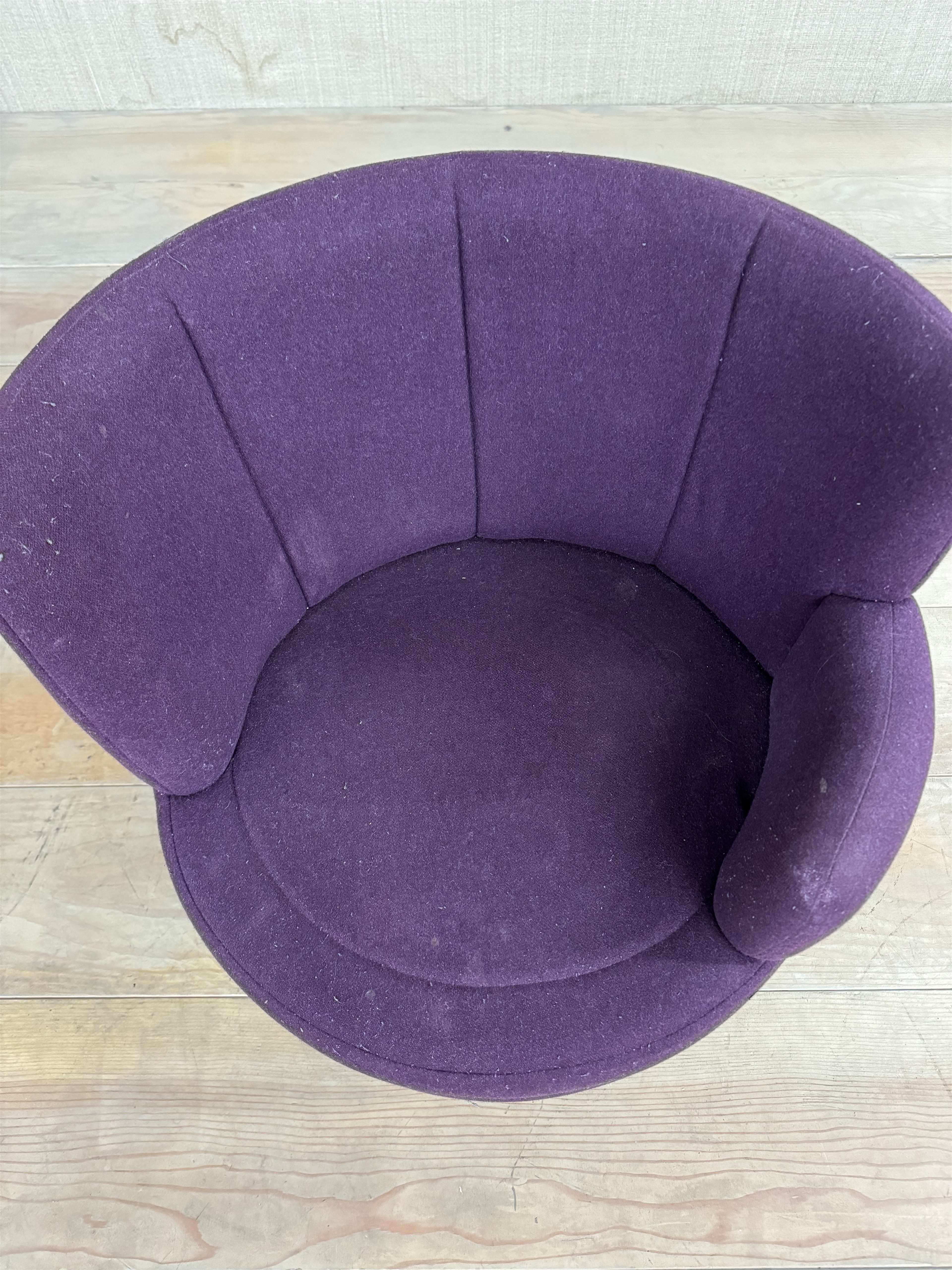a purple chair sitting on top of a wooden floor