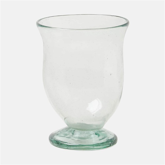 a glass vase sitting on top of a white table