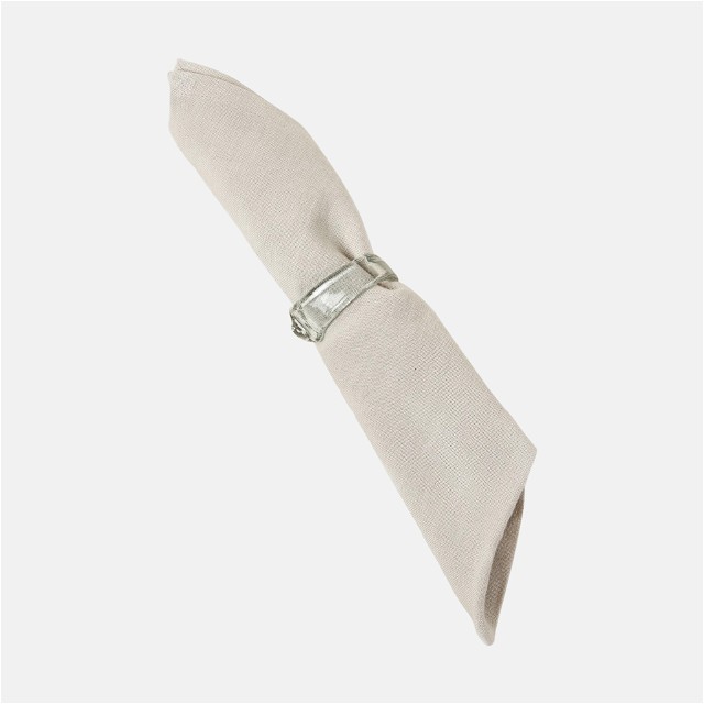 a white napkin with a silver buckle on it