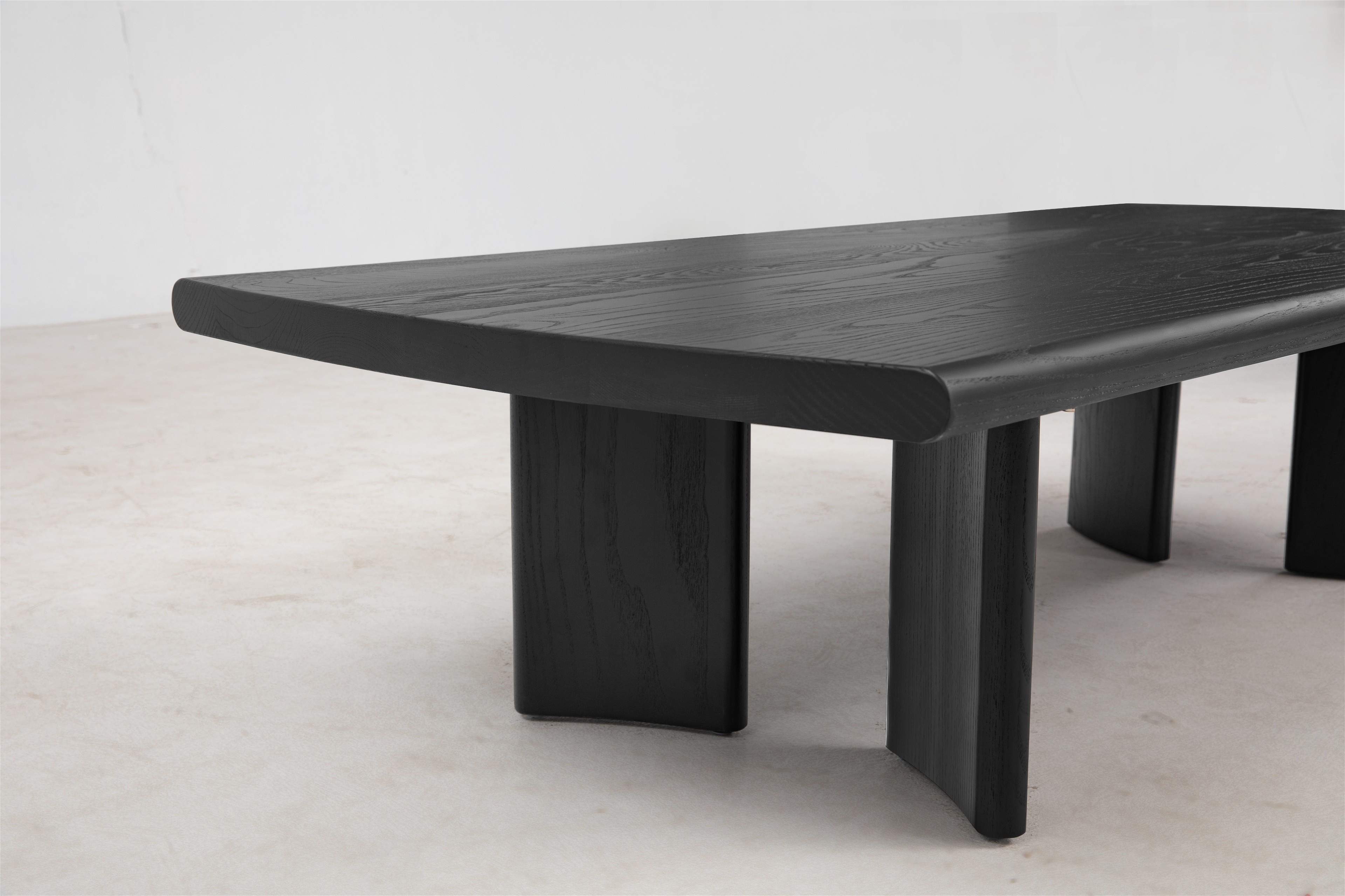 a black wooden table with a white wall in the background