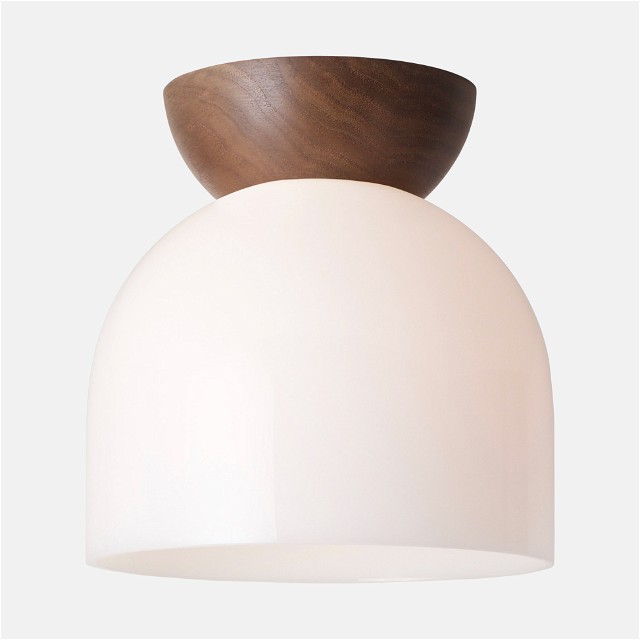 a white light with a wooden bowl on top of it