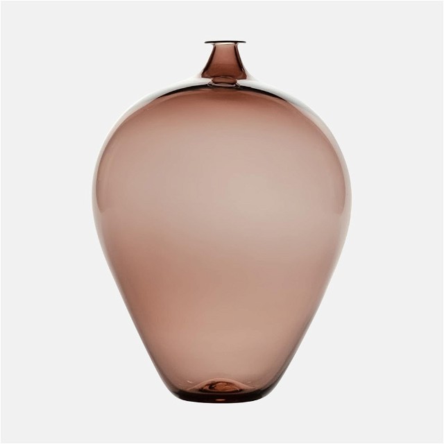 a brown vase sitting on top of a white table