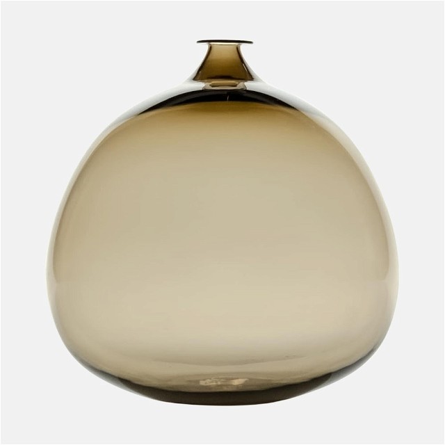 a glass vase with a gold top on a white background