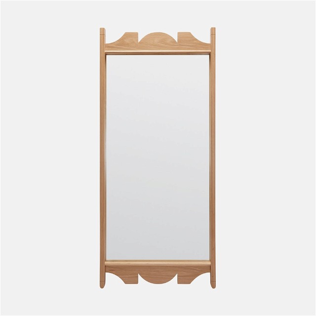 a wooden framed mirror on a white background