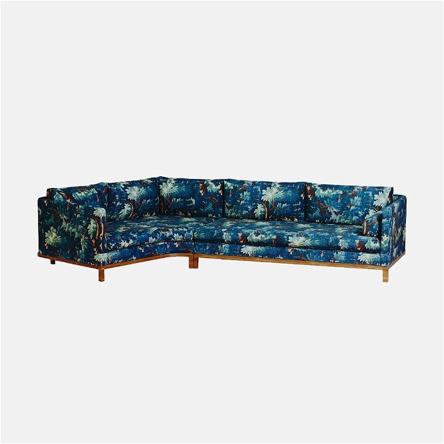 a blue couch with a floral pattern on it