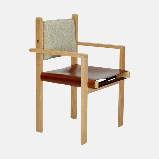 a wooden chair with a tan leather seat