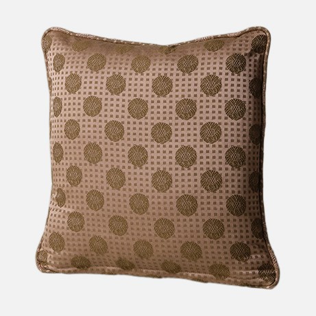 a brown pillow with a polka dot pattern on it