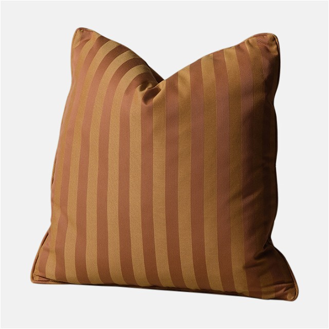 a brown and tan striped pillow on a white background