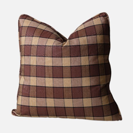 a brown and tan plaid pillow on a white background