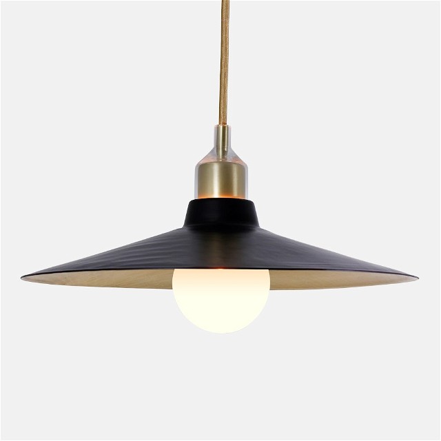 a black and gold pendant light hanging from a ceiling