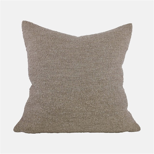 a gray pillow on a white background