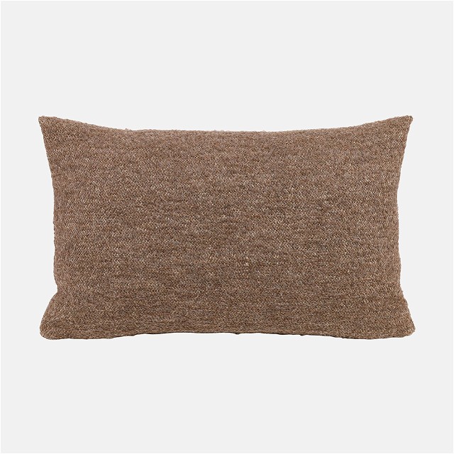 a brown pillow on a white background