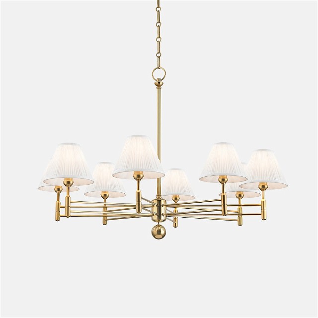 a brass chandelier with white shades