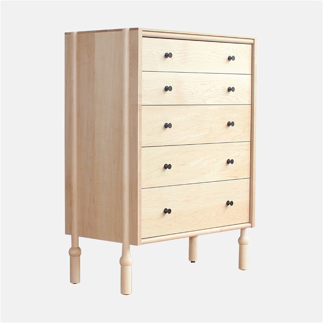 a wooden chest of drawers on a white background