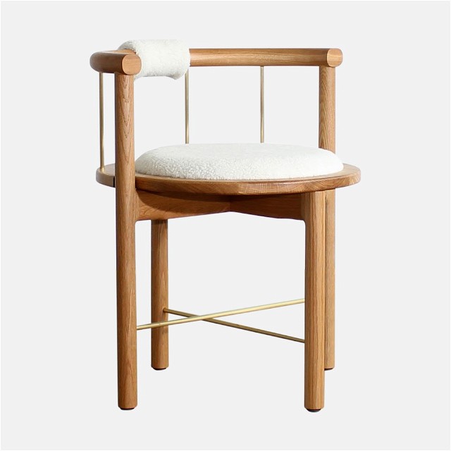 a wooden chair with a white cushion on it